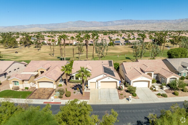 An elevated view of Sun City Palm Desert with homes surrounding nearby golf courses.