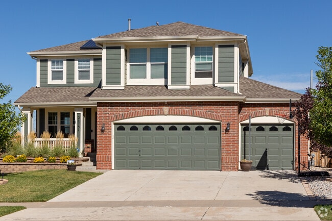 Two-story homes in Tollgate Crossing include covered porches and three-car garages.
