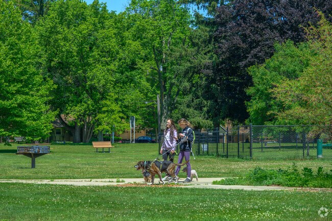A couple of West Douglas residents walk their dog at the Fairmount Dog Park.