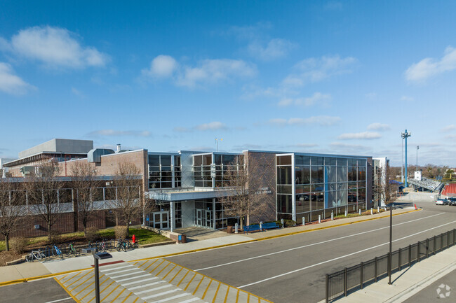 The front entrance of James B Conant High School features modern steel, glass, and brick.