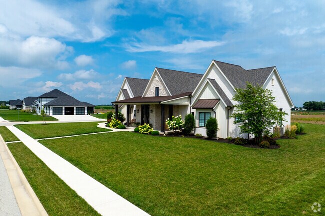 Coldwater, Ohio street with new homes, sidewalks, and open fields in the background.
