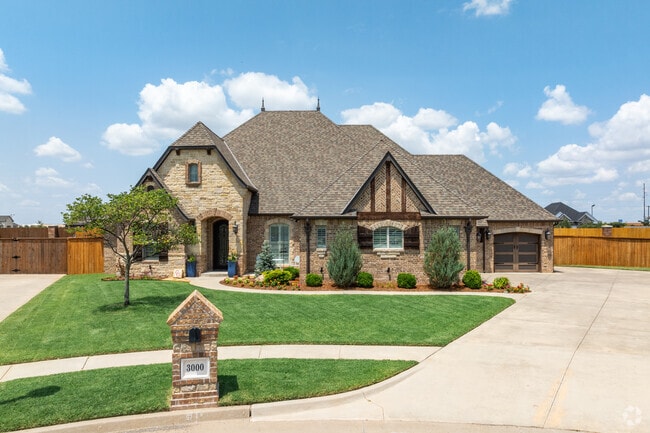 Moore city is home to many beautiful homes such as this Tudor with fabulous landscaping.