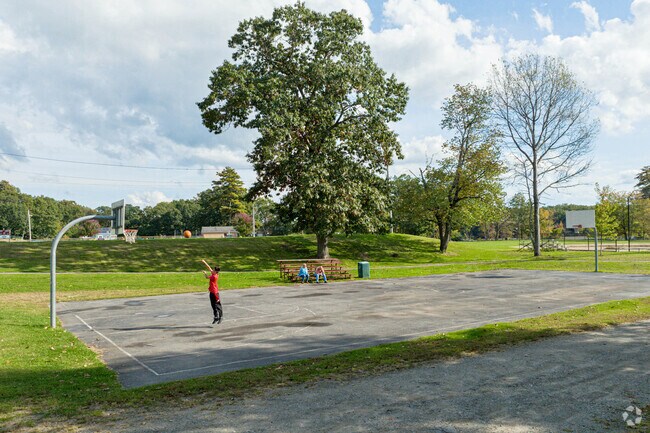 A kid practices their jump shot at a basketball court in Pirone Park.