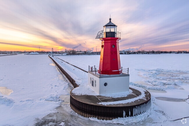 Menominee's iconic red North Pier Lighthouse keeps watch at the harbor opening.