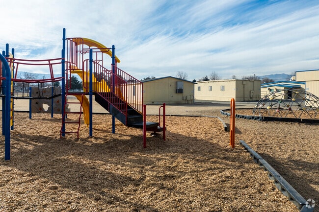 A large playground out in the back of Lincoln Park Elementary School.