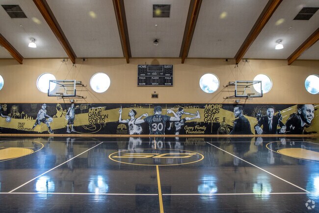 The Bushrod indoor basketball court has murals of the motivating Steph Curry.
