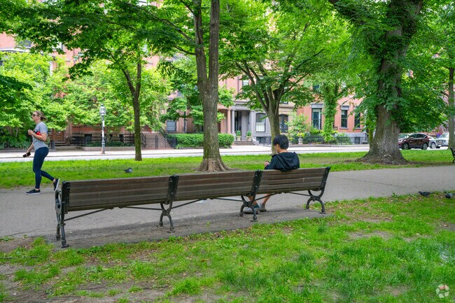 Sit and relax on one of the long wooden benches inside the Commonwealth Avenue Mall.
