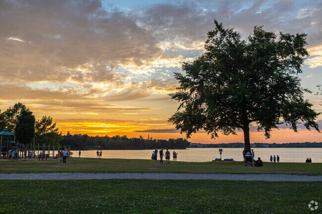 Residents gather alongside the lake at sunset for The Movies By The Lake near Greenwood.