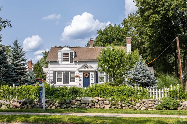 Cape Cod style home with stone fence in Waban.
