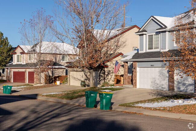 Craftsman-style homes featuring three-car garages line the street in Jackson Farm.