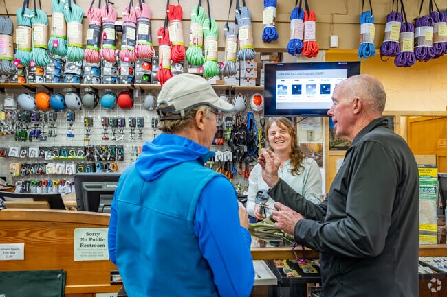 Shoppers at Eastside Sports search for an obscure piece of climbing equipment while cracking up the shop worker in Dixon Lane-Meadow Creek.