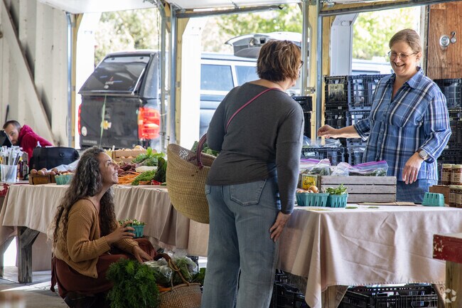 Locals fill their bags with produce at the Mountain Fresh Farmers Market in Oakland.
