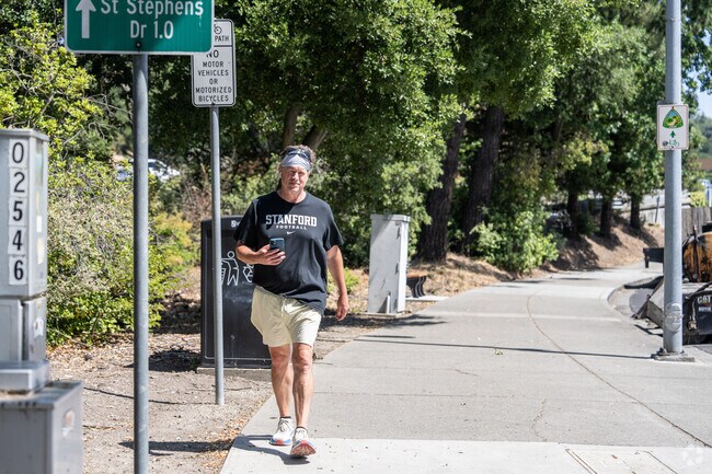 A man walks thoughtfully along the shaded path of St. Stephens Trail in Orinda Woods.