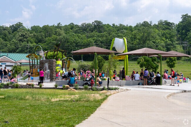 Families enjoy the new splash pad at Beckett Park in Beckett Ridge.