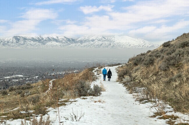 A couple enjoys a walk in the mountains in the East Bench.