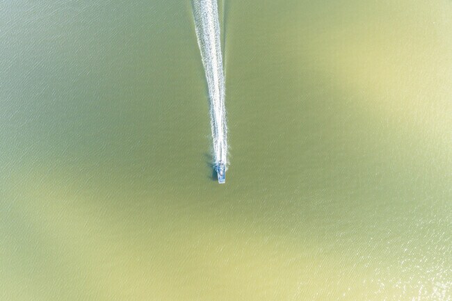 A boat heads down the river, just outside of Jones Creek, Texas