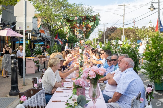 A traditional cheers starts The Long Table in Hyannis.
