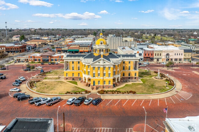 The heart of Marshall, Texas, where the iconic courthouse stands proudly at the center of town, bustling with local life and community spirit.