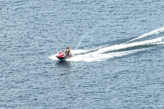 Jet skiers cruise across the lake in Acton, Maine, on a warm summer afternoon.