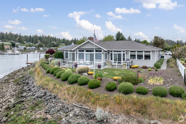 Enjoy waterfront living surrounded by nature in a Shelter Bay rambler home.