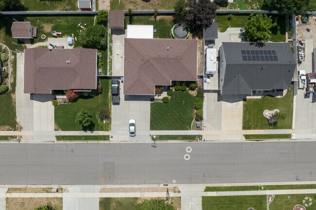 An aerial view of well kept yards with different shades of green.