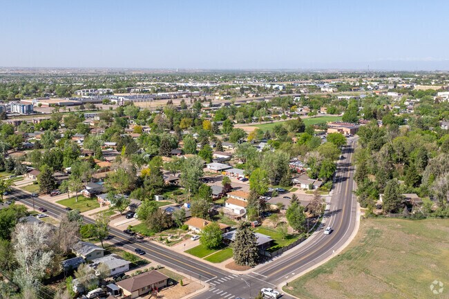 Aerial view of Rolling Hills, Greeley: tree-lined streets and spacious homes in a peaceful neighborhood near the University of Northern Colorado.