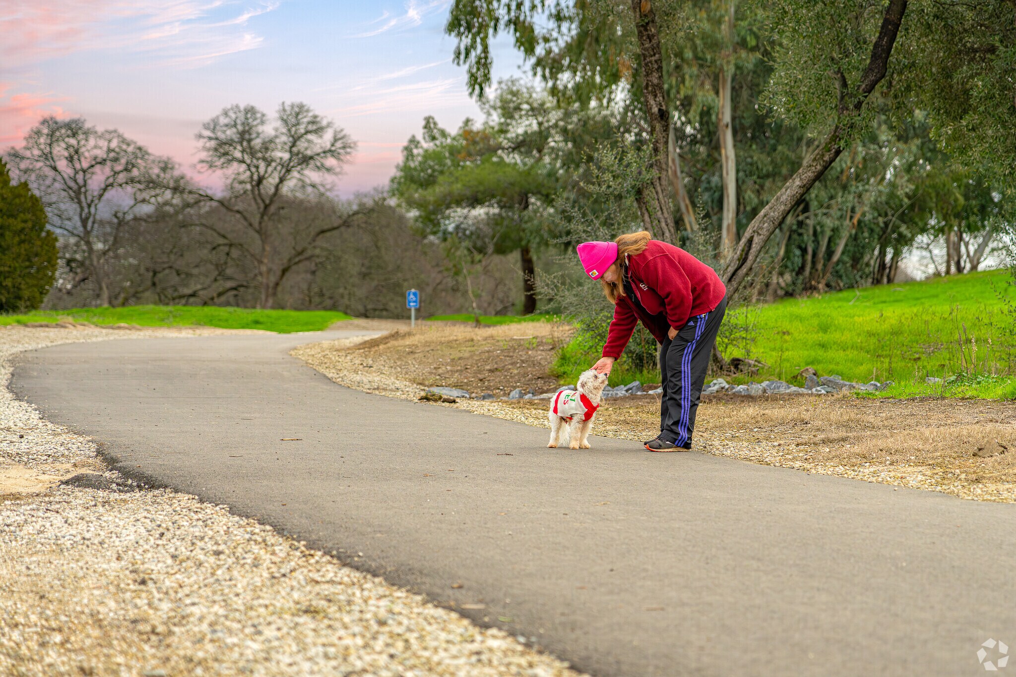 Woman walks best friend through Sunset Whitney Recreation Area near Clover Valley Woods.