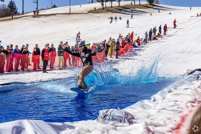 Wonder Center residents cheer on the contestants as they glide across the pond at the Slush Cup.