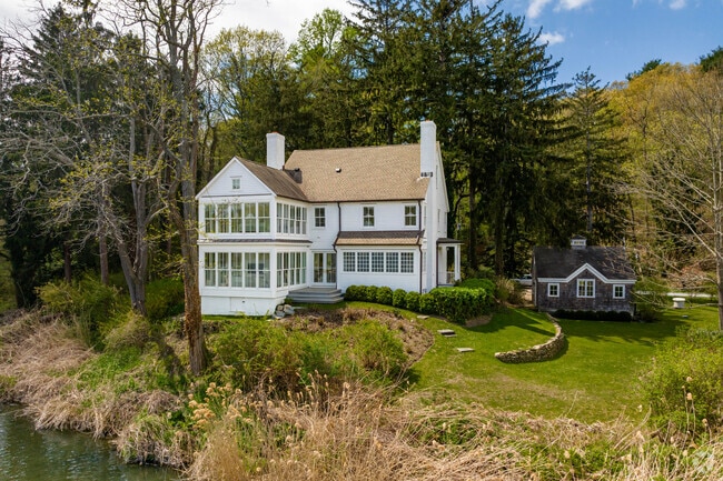 Beaver Lake in Mill Neck is bordered by homes with scenic views, often Colonial Revival or Tudor.