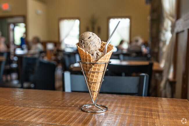 Two scoops of Brookie Dough ice cream melt in a waffle cone at Fox Meadows Creamery in Clay.