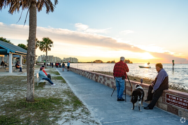 Residents and visitors of Gulf Coast Acres flock to see the sunset along the water line.