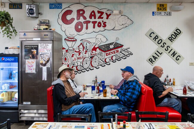 Customers eating under the Crazy Otto's Diner graphic in Acton.