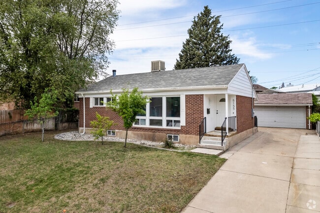 A lovely brick home with white details in Washington Terrace.
