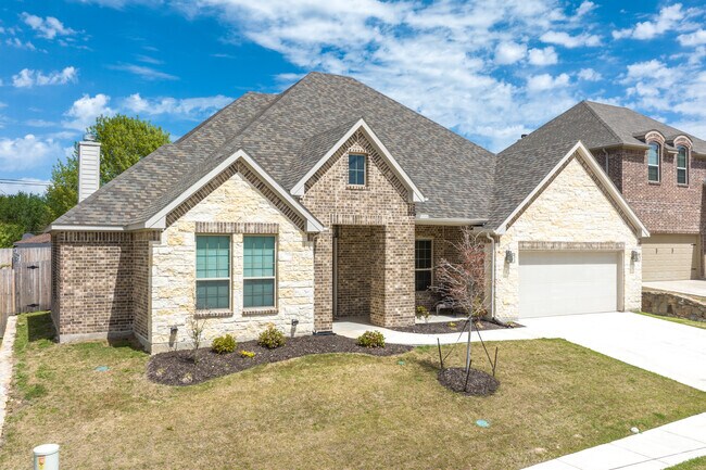 Newer homes include traditional brick houses with built-in garages in Decatur, TX.