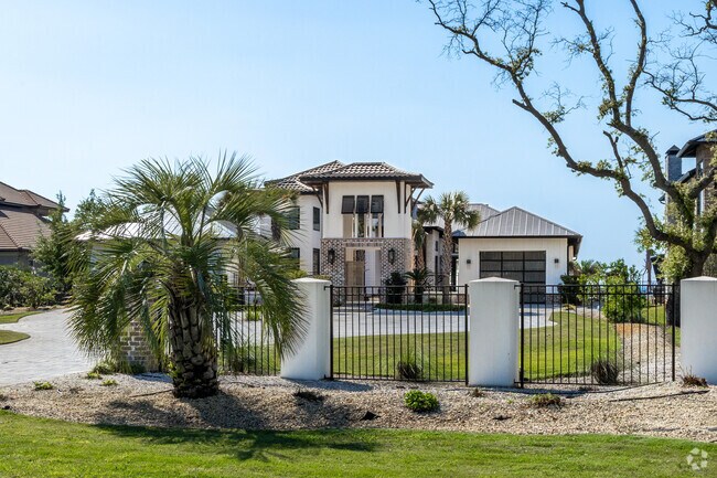 Large single family multi-million dollar homes line the shorelines of Miramar Beach.
