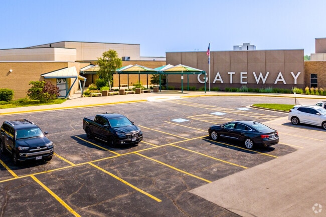 Gateway signage and parking lot to the building.