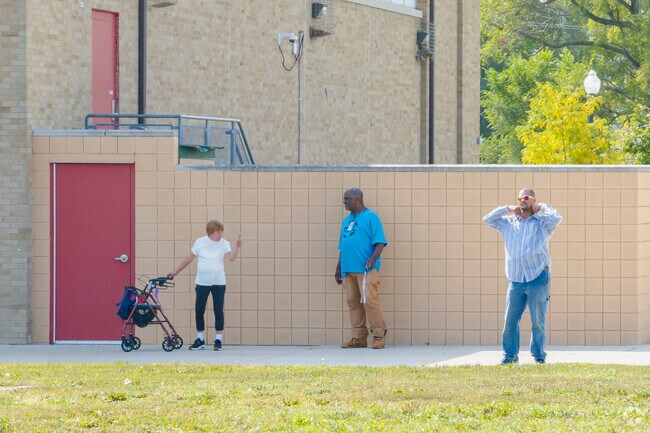 Some neighbors are catching up next to the Arthur Lesow Community Center.