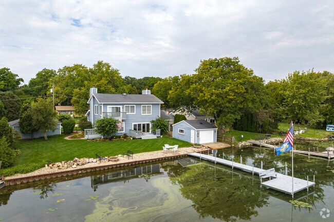 A lakefront escape home, complete with boat dock, sits next to Round Lake.