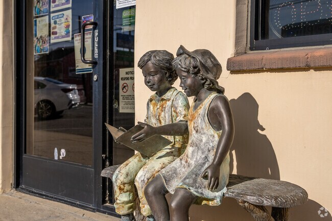 The Saticoy Library has a statue of 2 children reading books.