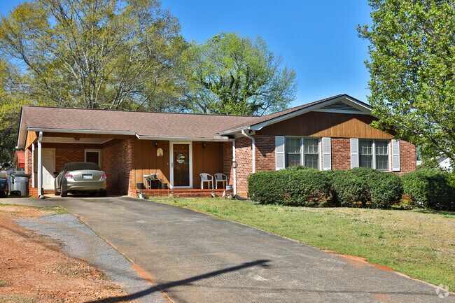 Many homes in Gantt are brick and have carports.