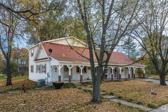 This farmhouse-style home in Wheatfield has a long porch for relaxing.