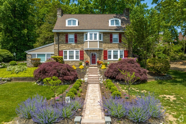 Stone colonial homes throughout the Abington neighborhood are adorned with colorful landscaping.