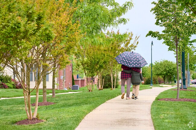 Clarksburg, Maryland residents walk home in a light spring rain shower.