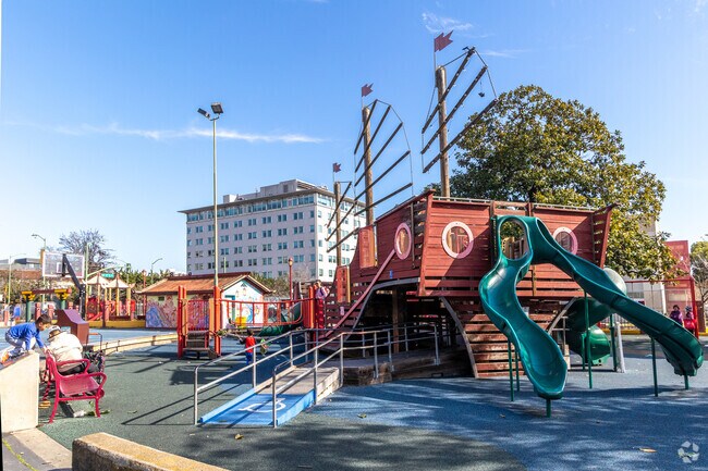Kids play on a structure at the Lincoln Square playground modeled after a Chinese junk ship.
