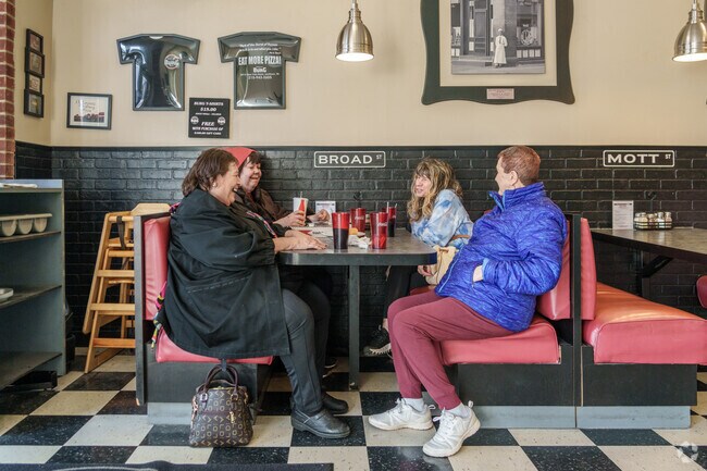 Friends gather at DeLorenzo's The Burg Pizza for tasty Italian fare and laughs.