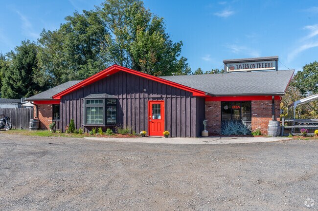 Tavern on the Hill in East Haddam showcases rustic charm with its dark wooden siding.