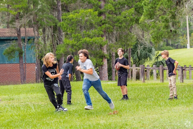 Kids enjoy the large green spaces at Lecanto Park.