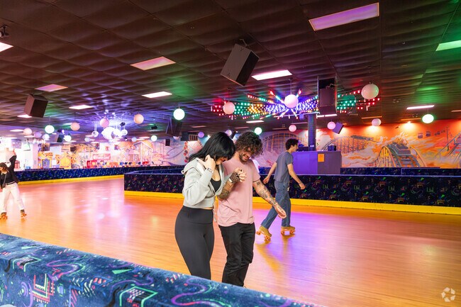 Couples can skate together in the lively atmosphere of Skate Zone in Salem Village.