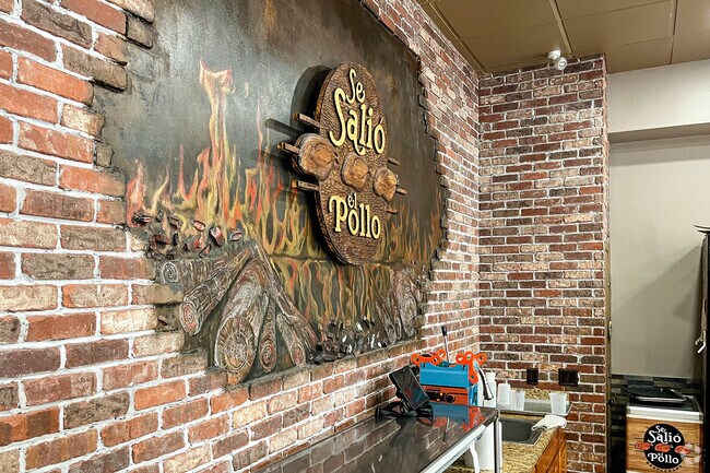 Se Salio El Pollo's decorative wall sign says great food served here in Perth Amboy, NJ.