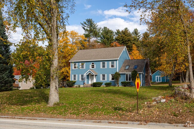 Colonial homes in Litchfield, NH feature large front lawns and small sheds in the back yard.
